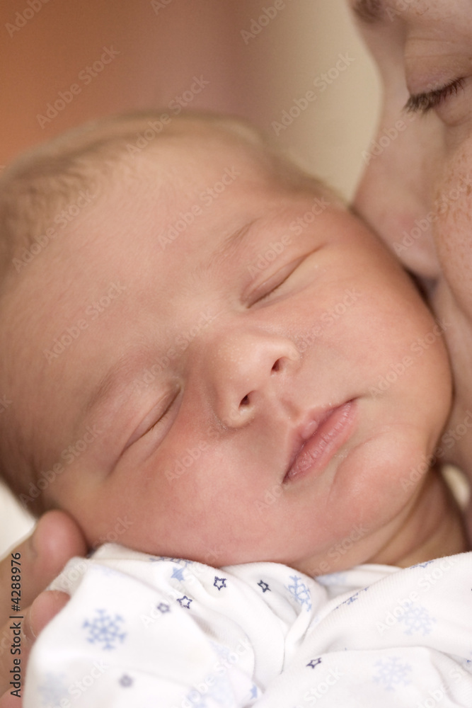 Mother kissing newborn baby boy