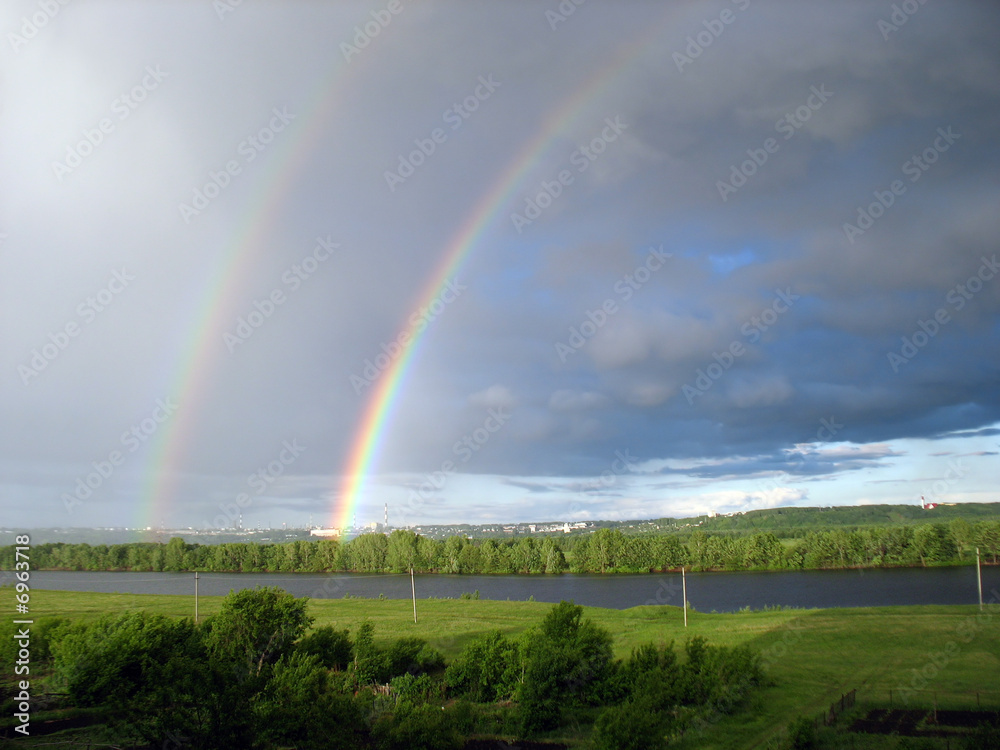 landscape with rainbow over lake