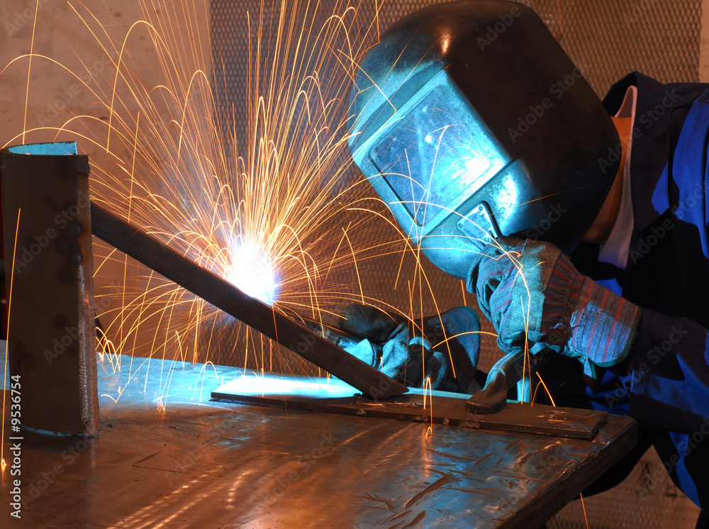 Factory welder doing his hard job