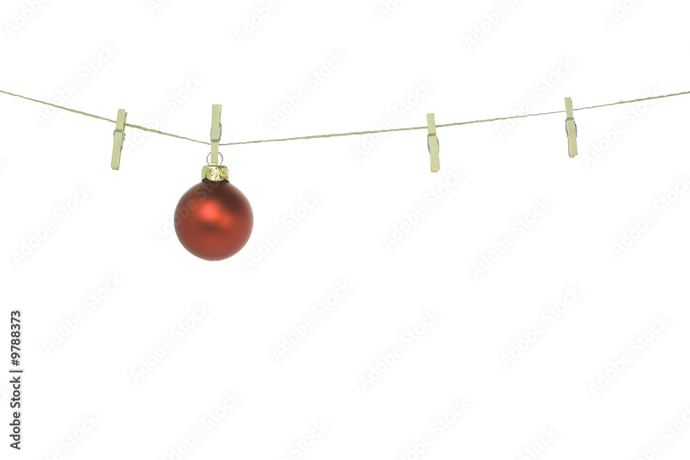 Christmas ball on clothes line. White background