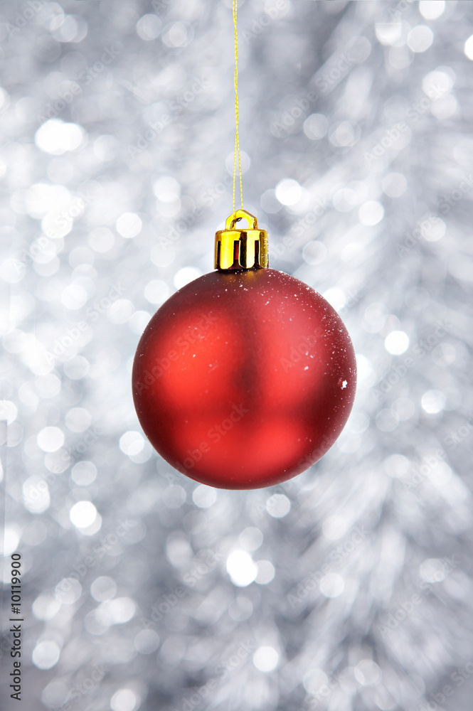 Red Christmas-tree decoration on a silvery background