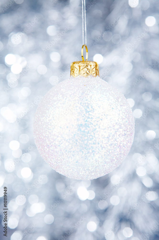 White Christmas-tree decoration on a silvery background