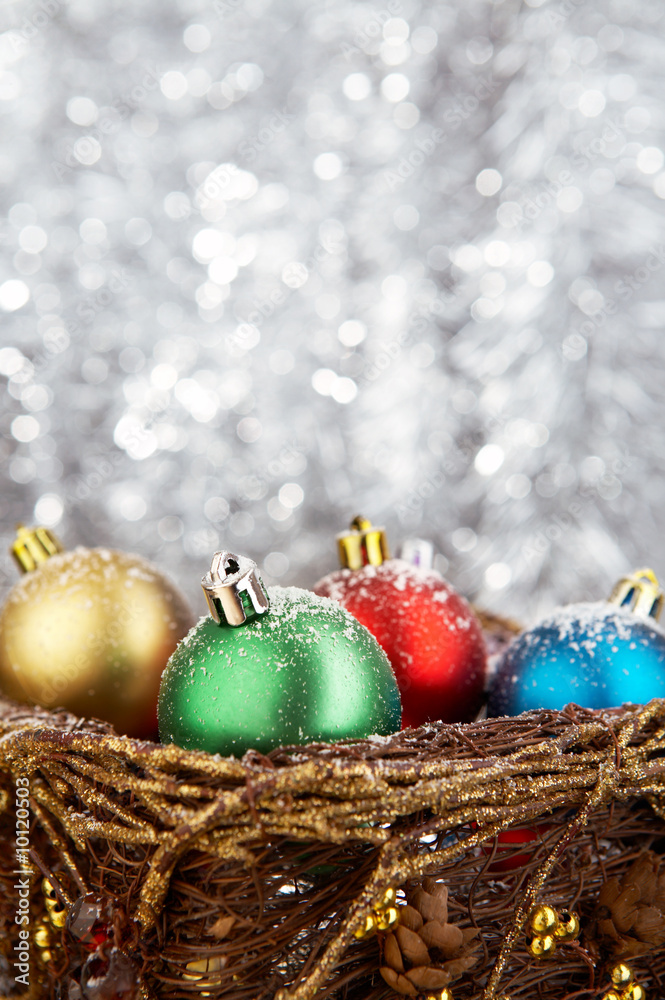 Multi-coloured balls on a silvery flickering background