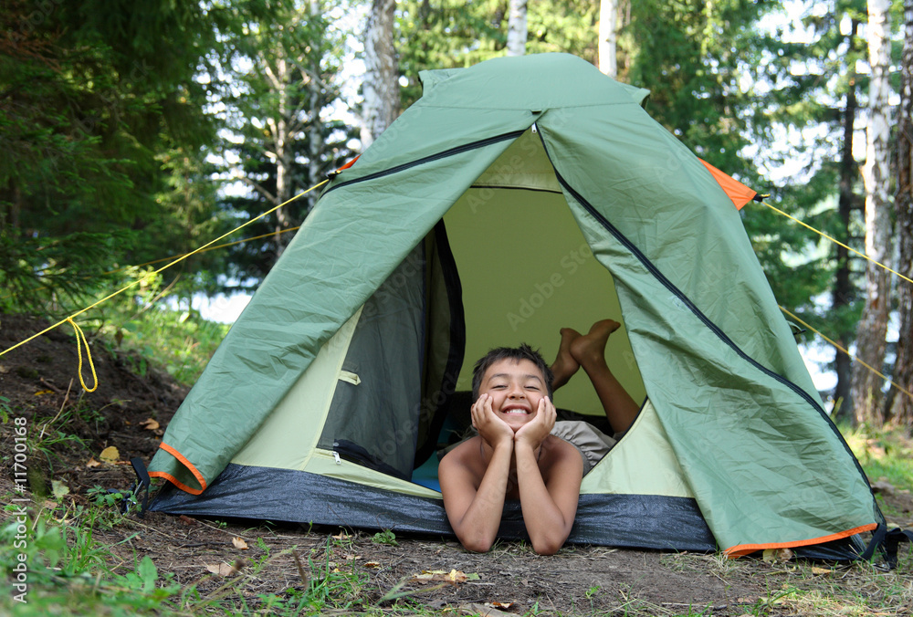 happy boy in camping tent