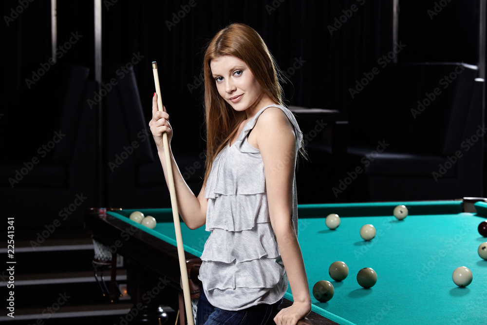 The girl at a billiard table