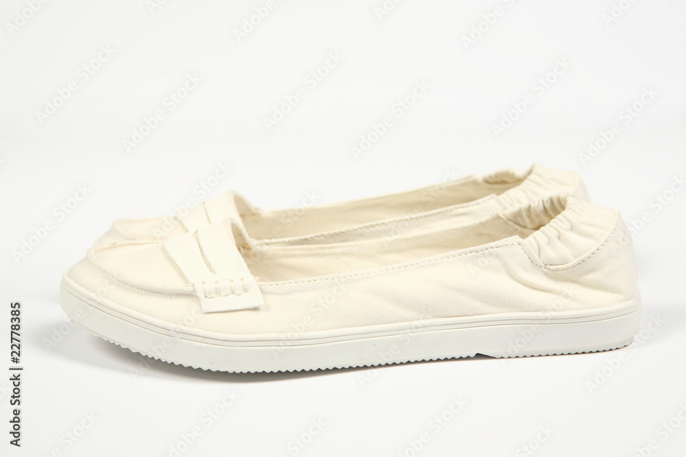 a pair of white women shoes and white background