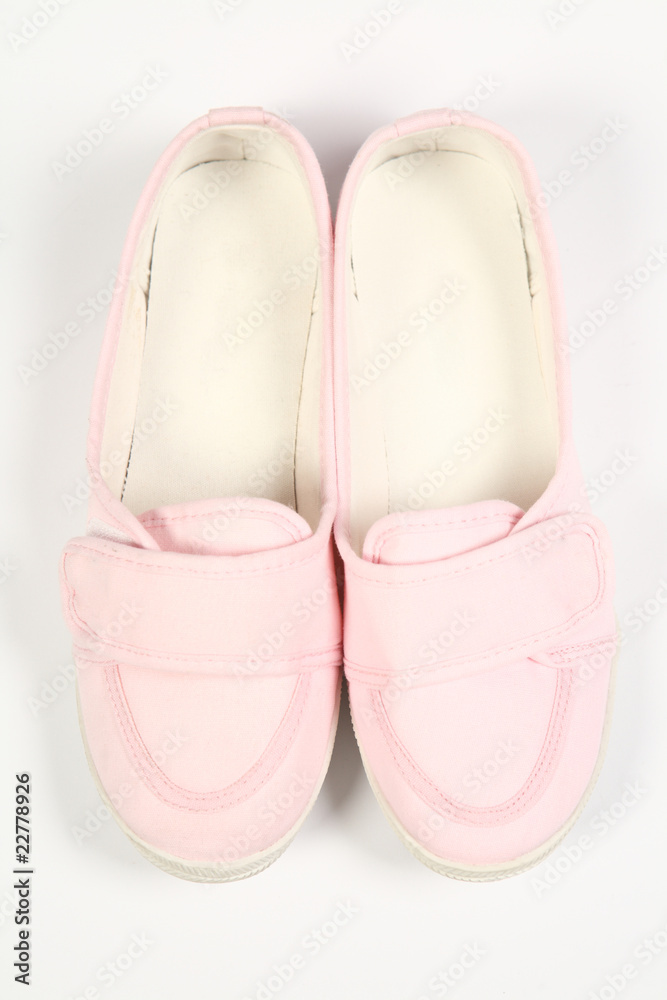 a pair of pink women shoes and white background