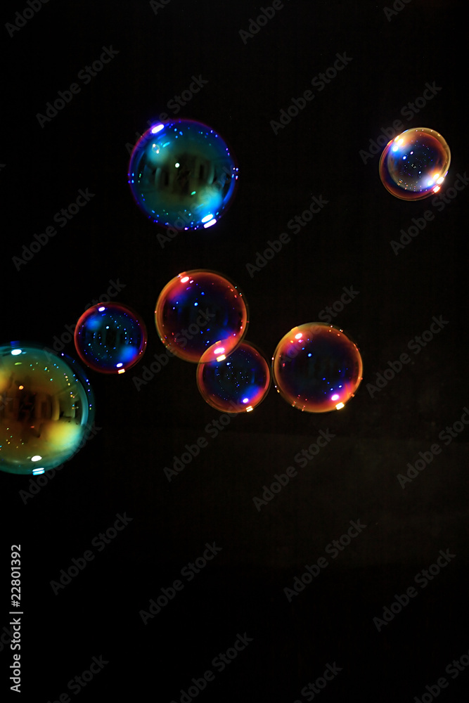 Soap bubbles on black background .