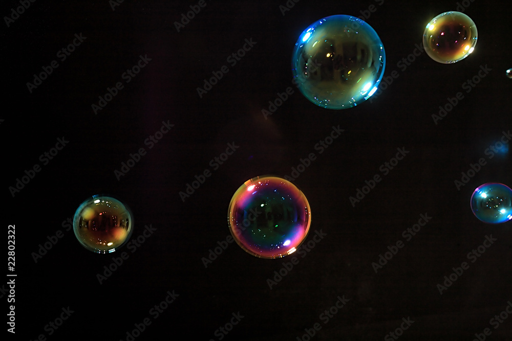 Soap bubbles on black background .