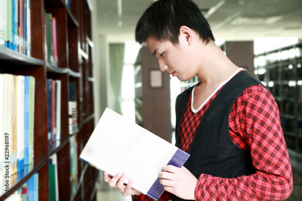 asian boy studying in library