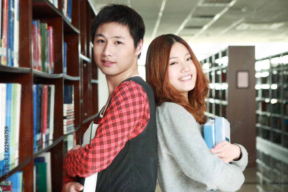 boy and girl studying in library