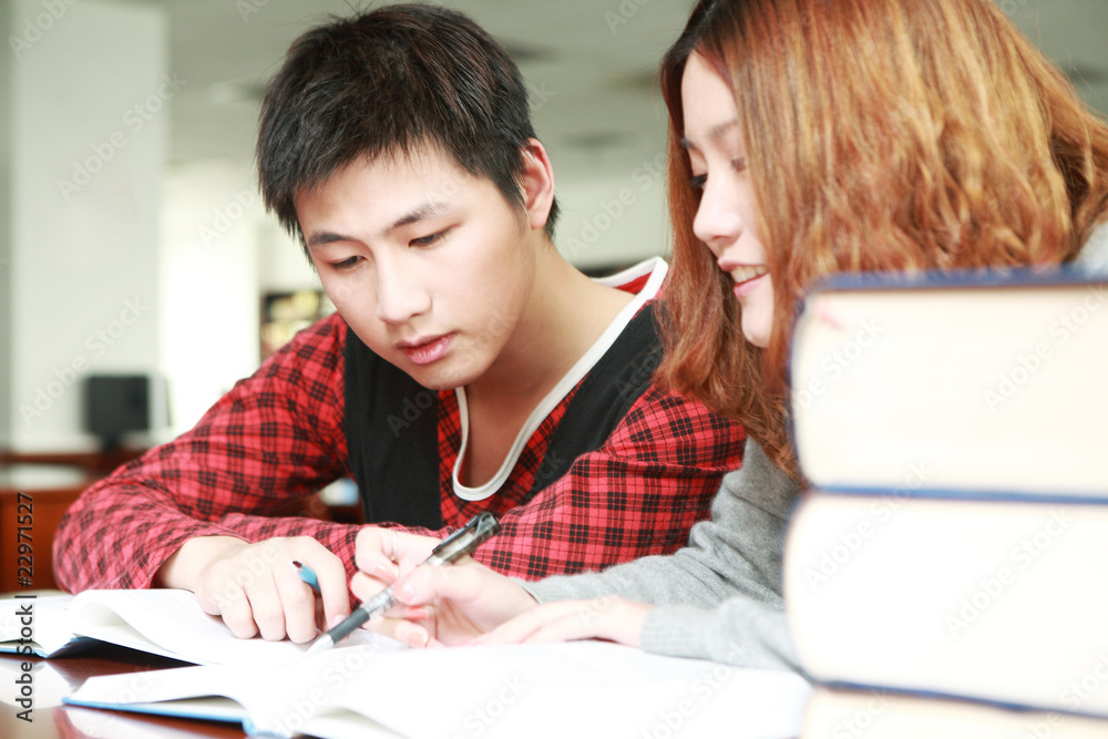 asian boy and girl studying in library