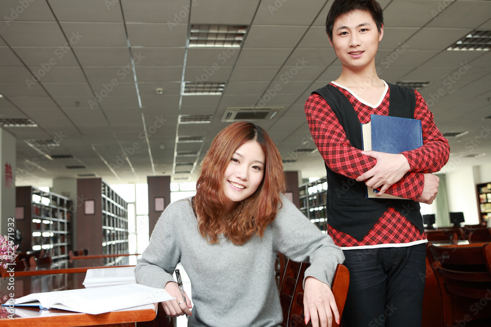 asian boy and girl studying in library