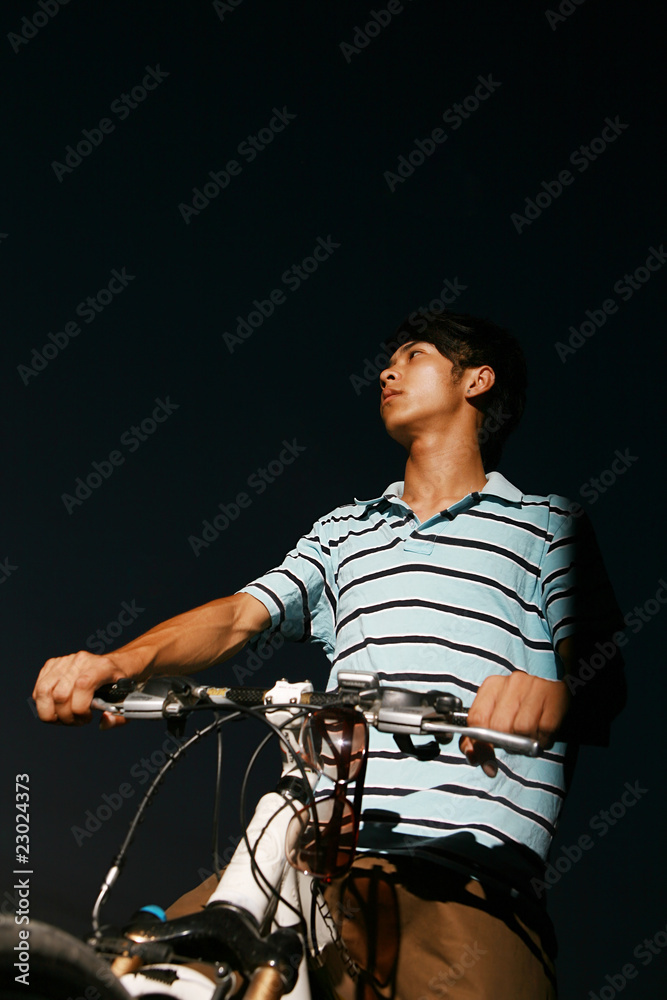 young asian man with bike