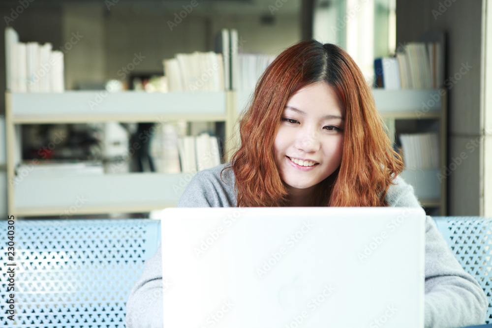 asian girl using laptop in classroom