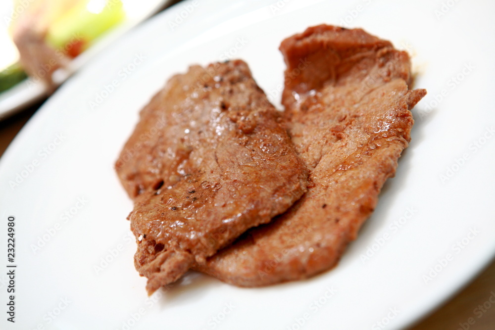 a steak with in a white plate