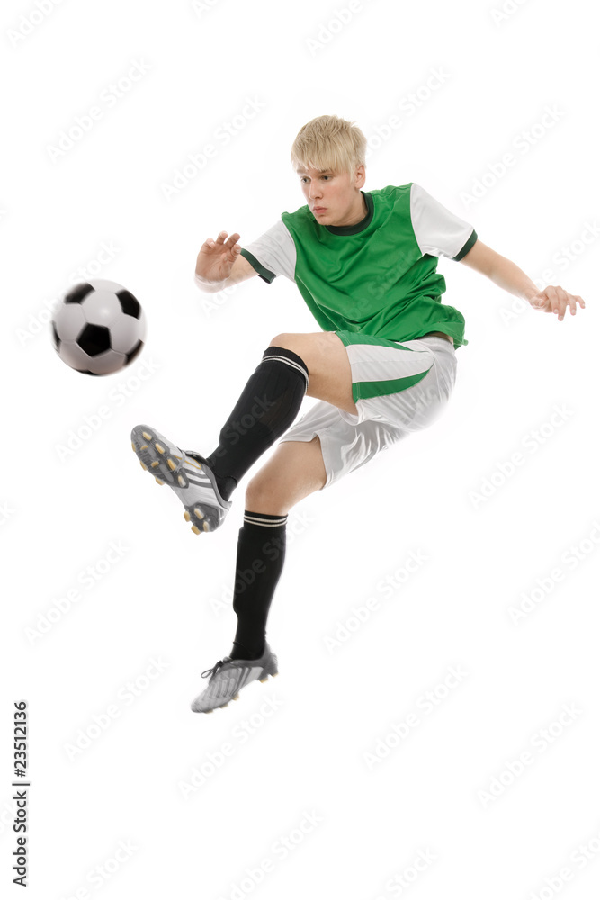 Soccer player kicking the ball isolated on white