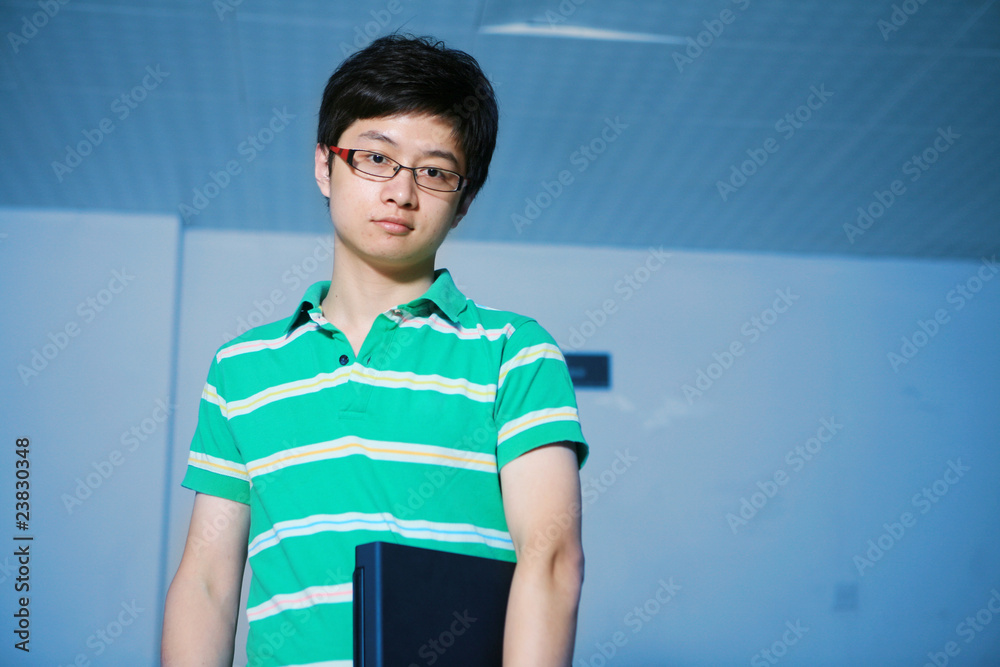 asian male student with laptop