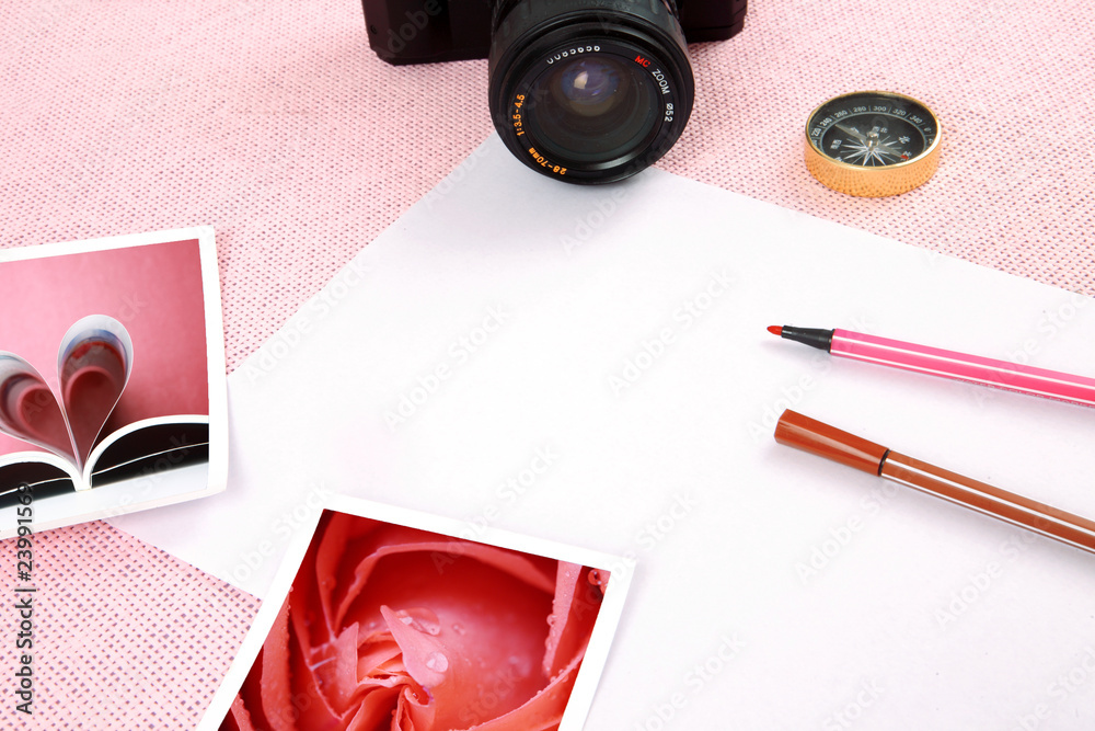 Clutter of objects stacked on pink background