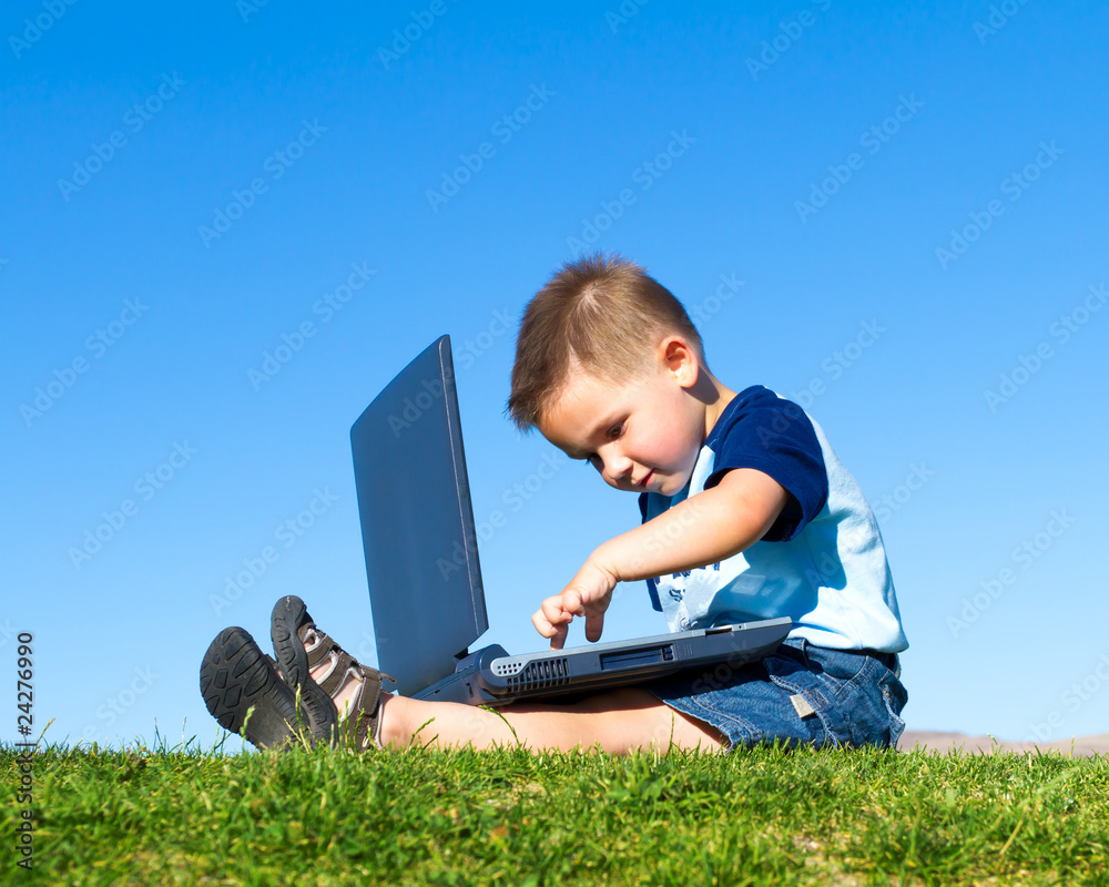 Boy playing with laptop