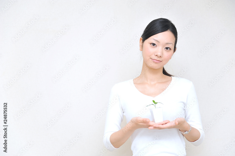 japanese girl holding a small plant