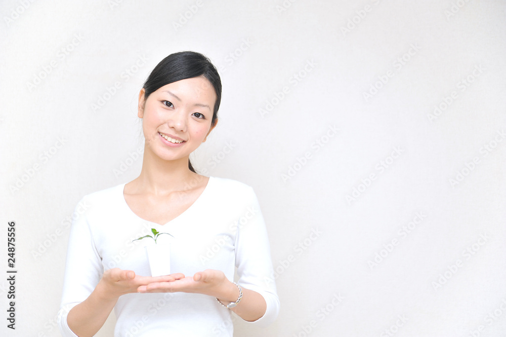 japanese girl holding a small plant