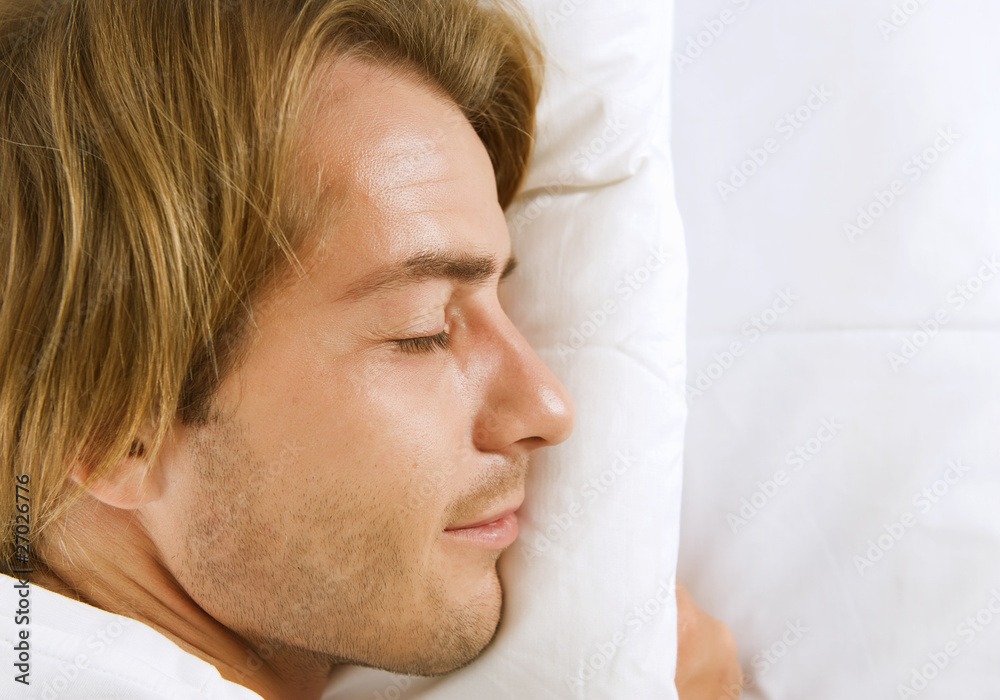 Young Man Sleeping in his Bed