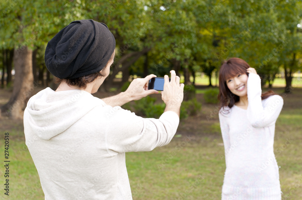 a portrait of young couple taking a photo