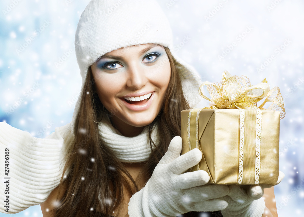 Beautiful Happy Girl with Christmas Gift.Snow