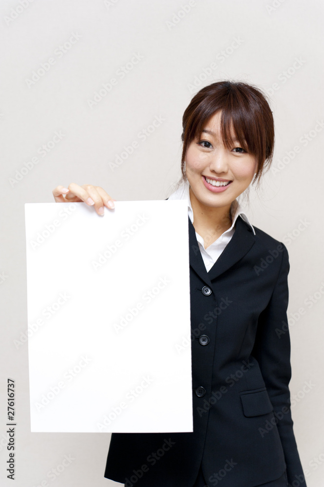 a portrait of young business woman taking a blank white board