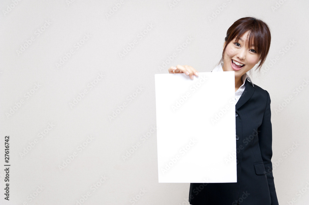 a portrait of young business woman taking a blank white board