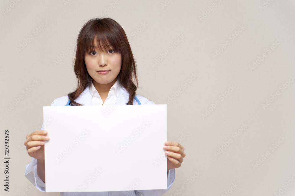 a portrait of young doctor taking a blank whiteboard