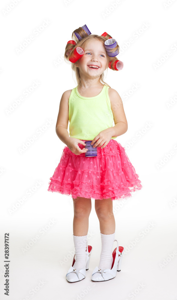 Little girl play fashion in mothers shoes and rollers