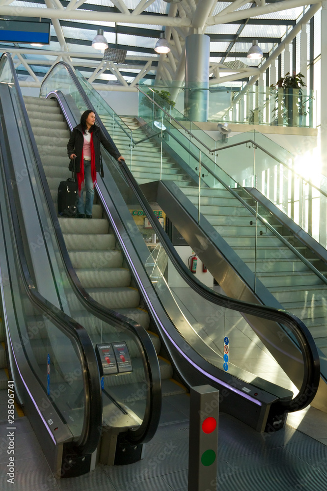 Businesswoman on airport escalator