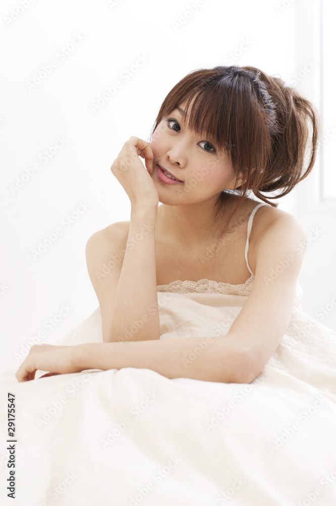 a portrait of beautiful asian woman on the bed