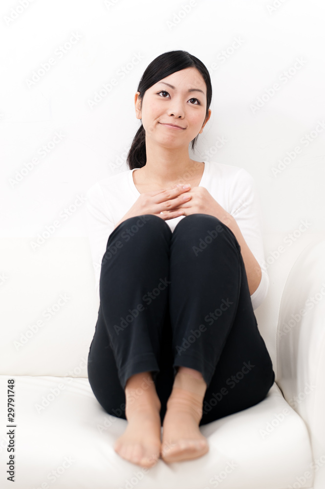 beautiful asian woman sitting on the sofa