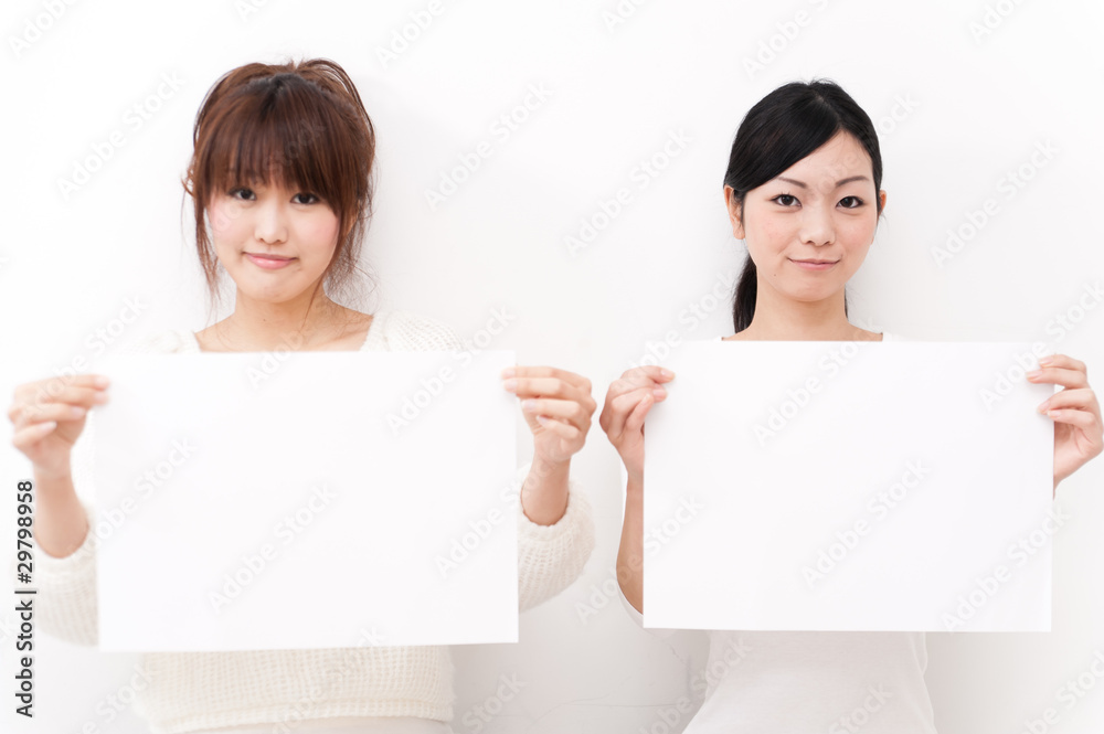 two beautiful asian women taking blank whiteboard