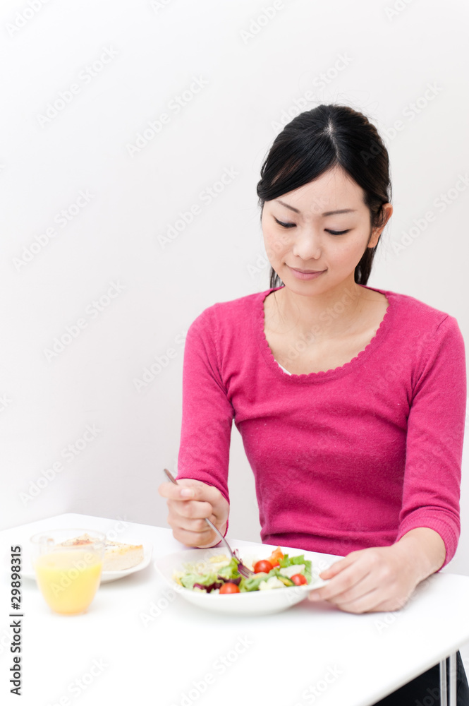 beautiful asian woman eating breakfast