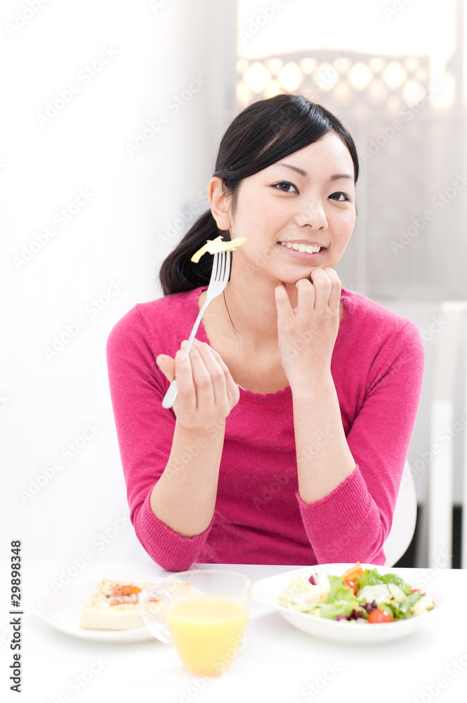 beautiful asian woman eating breakfast