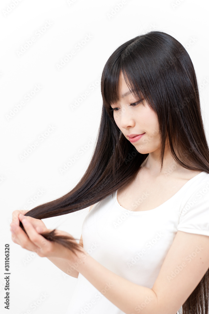 beautiful asian woman taking care of her hair