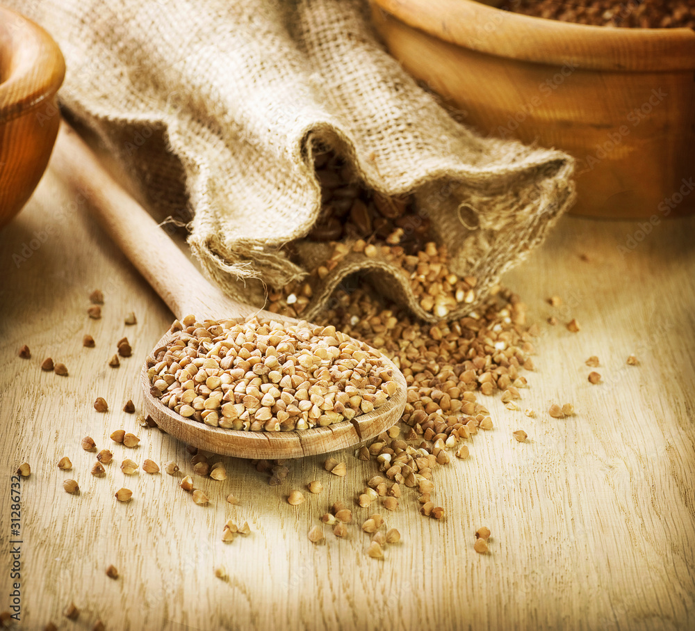 Buckwheat groats in a wooden spoon