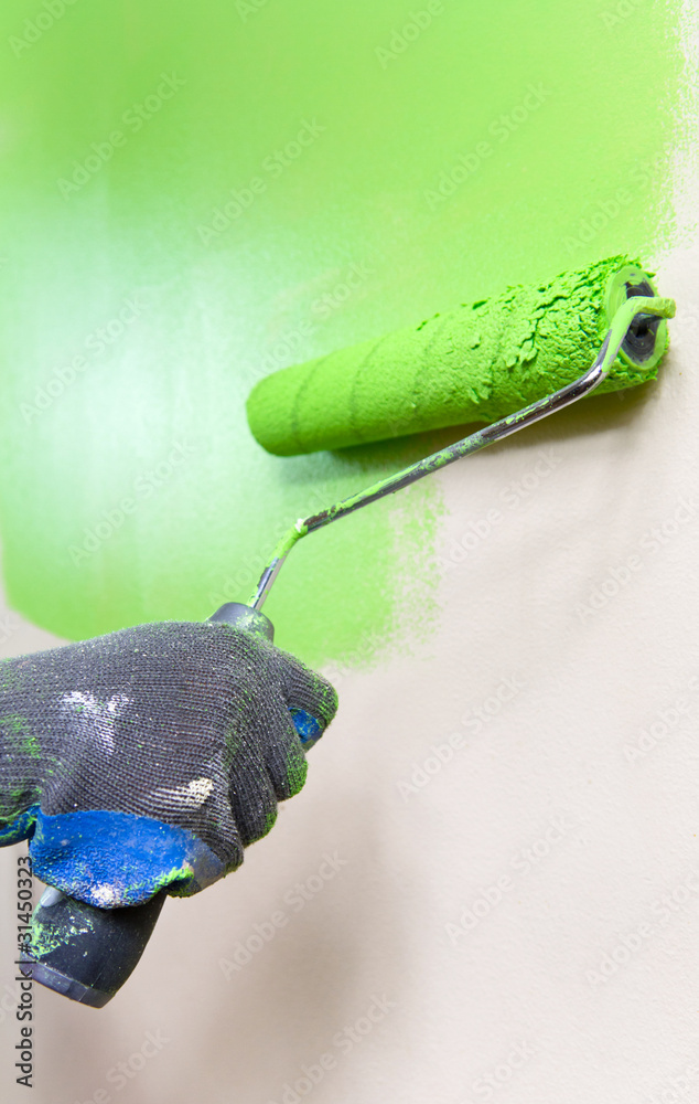 Roller painting wall on green color