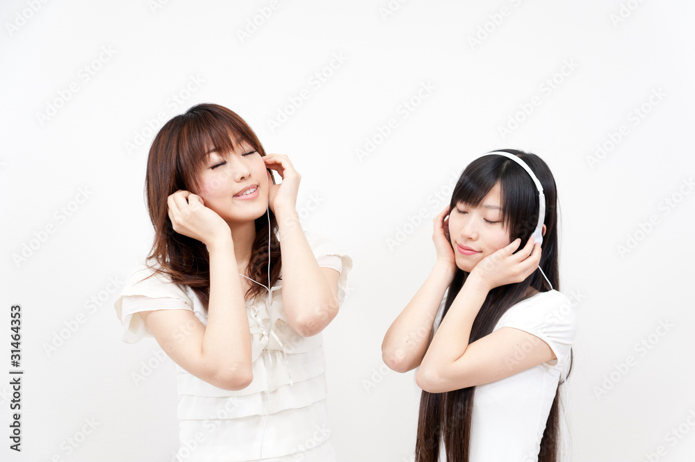 two beautiful asian women listening to music