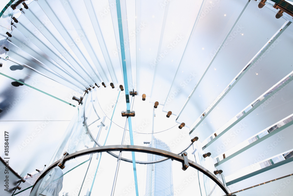 modern glass spiral staircase in shop with motion step