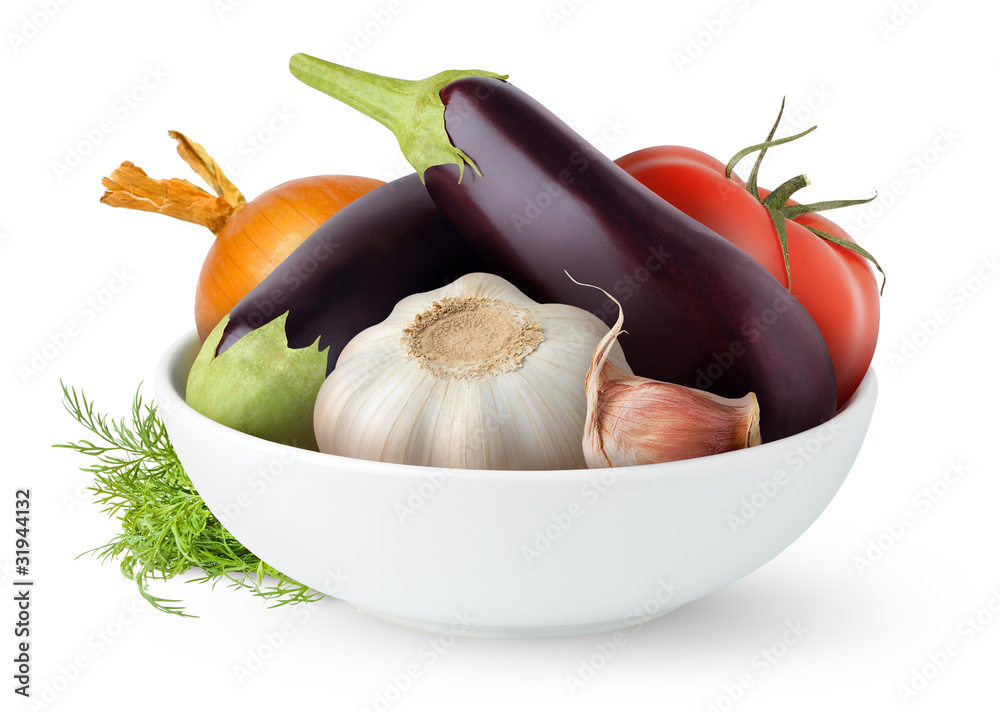 Isolated vegetables. Fresh eggplants, tomato, garlic and onion in a bowl isolated on white backgroun