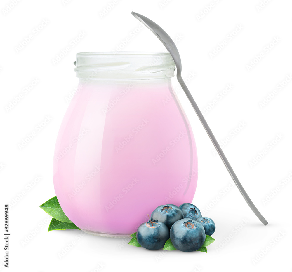 Isolated yogurt. Open glass jar of fruit yogurt with spoon and fresh blueberries isolated on white b