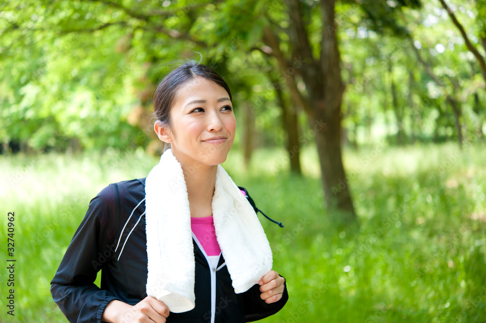 beautiful asian woman jogging in the park