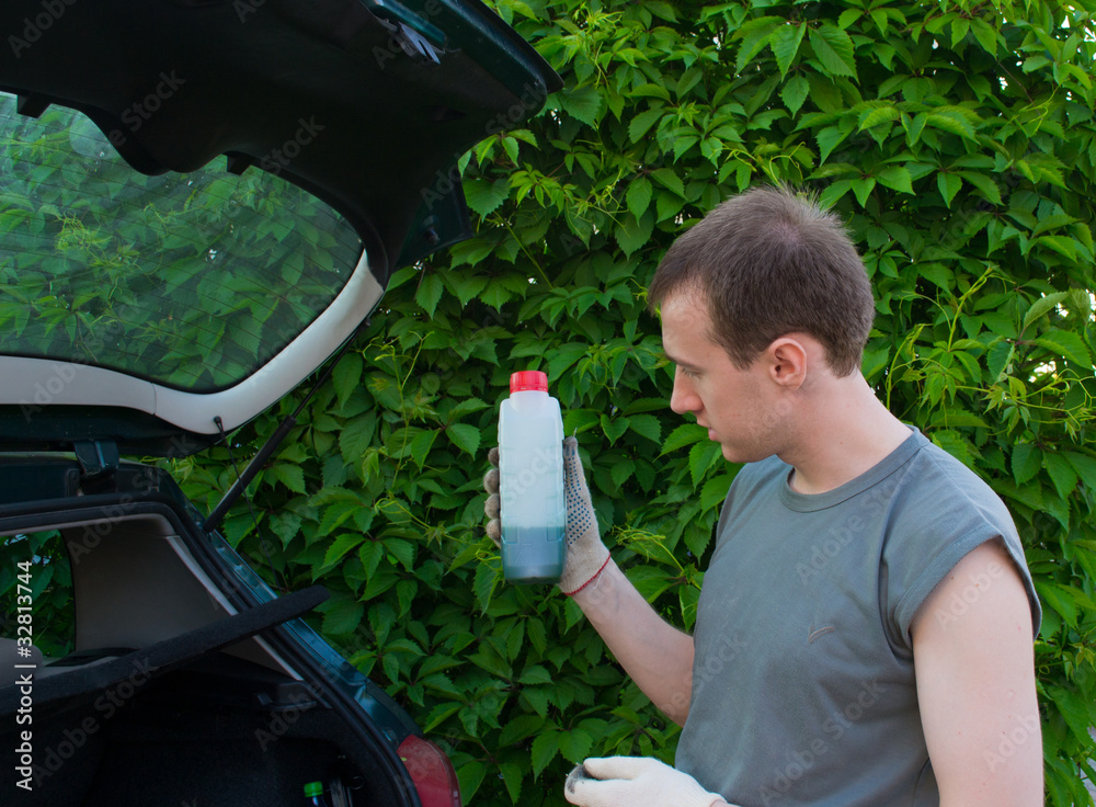 The man with a lubricating oil bottle