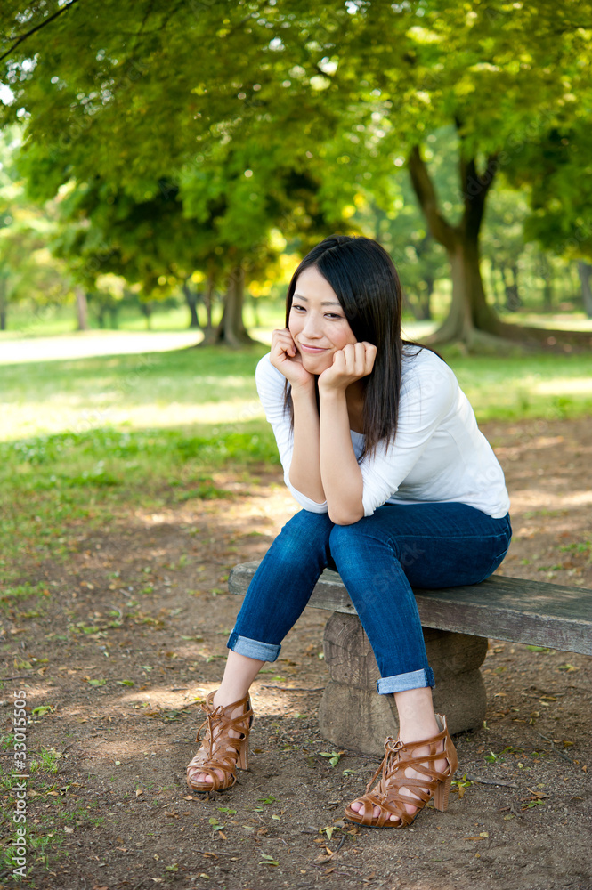 beautiful asian woman relaxing in the park