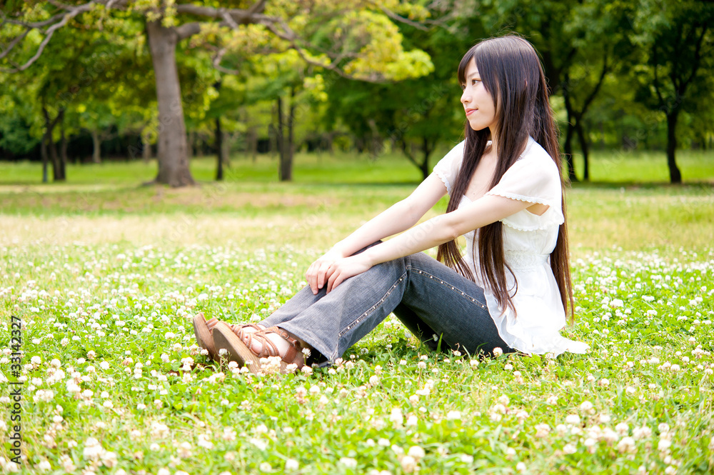 beautiful asian woman relaxing in the park